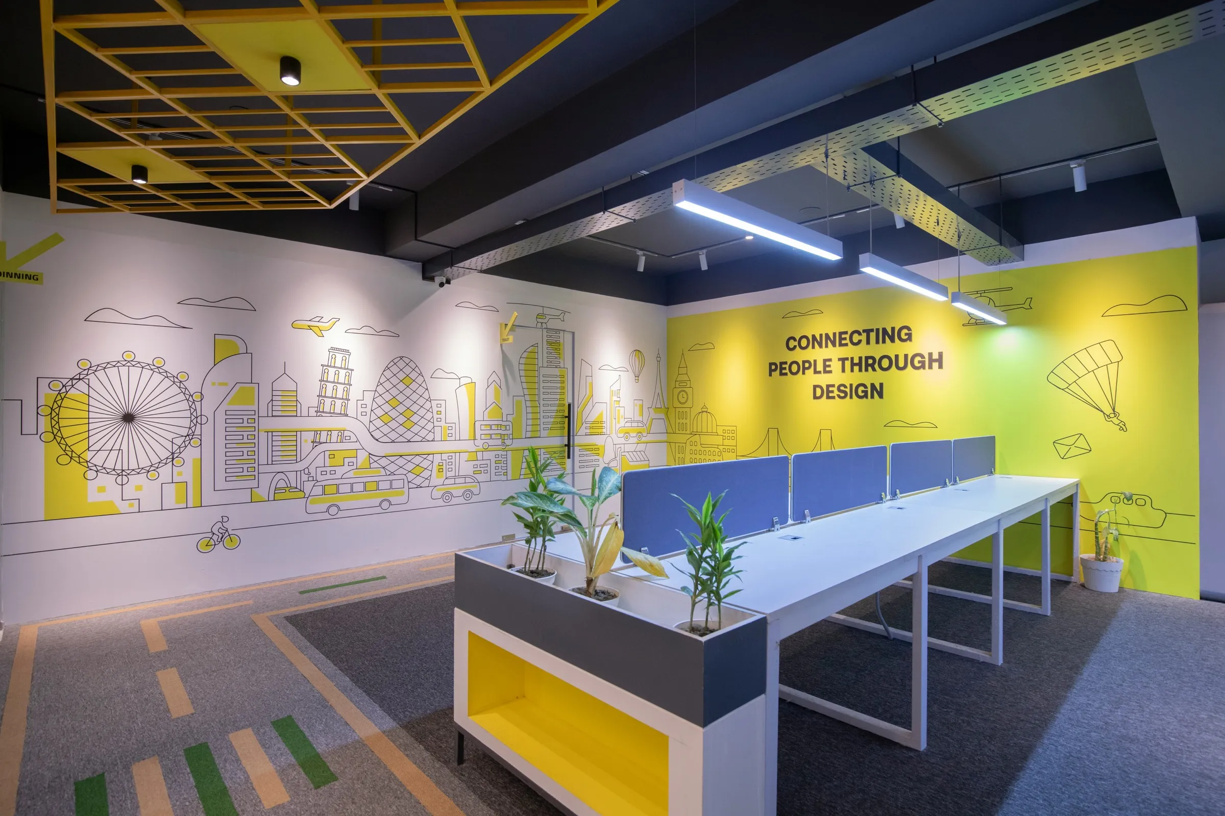 Büro mit Linienzeichnung einer Stadt und großem Schriftzug an der Wand